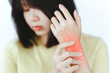 Women have wrist pain from work or exercise. Health care concept.