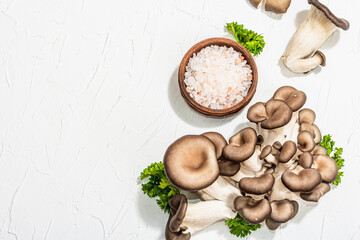 Fresh oyster mushrooms with parsley and sea salt. Healthy ingredient for cooking vegan food