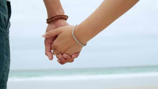 Back, couple and holding hands at beach, love and loyalty of save the date marriage. Closeup hand of man, woman and ocean with trust, support and peace for travel, freedom and care for life partner