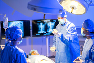 Professional anesthesiologist doctor medical team and assistant preparing patient to gynecological surgery performing operating with surgery equipment in modern hospital operation emergency room
