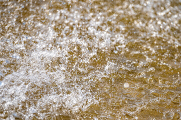 Water splash with small drops in the fountain. Abstract natural, selective focus, copy space