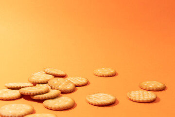Cookies on orange background. Artistic background for pastry or sweet snacks