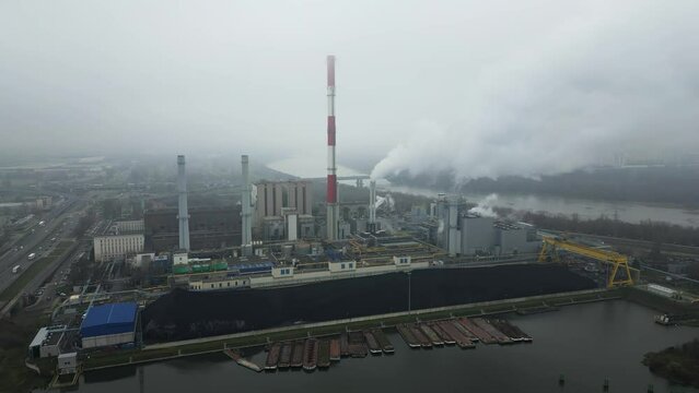 Energy extraction from coal, termal power station, view from height of the pipes in the smog, environmental issues, aerial view.