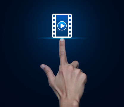 Hand pressing play button with movie flat icon over blue background, Business cinema online concept