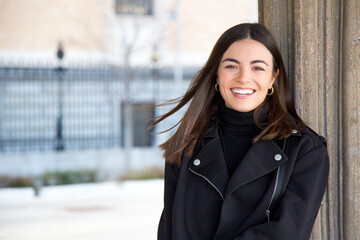 Young woman smiling at camera in the street