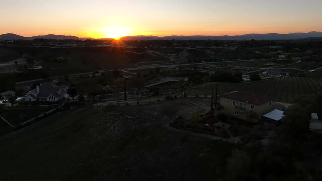 Aerial View of Sunset Sunlight Above Temecula City Homes and Buildings, California USA