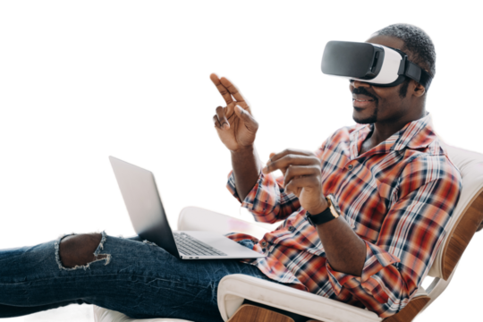 African american man in virtual reality glasses works or play video game on laptop, sitting in chair