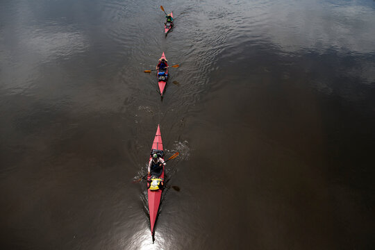 Three women paddle their kayaks down the Onon river in northern Mongolia.