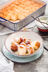 Buchteln, sweet rolls made of yeast dough with milk and butter, served with vanilla sauce