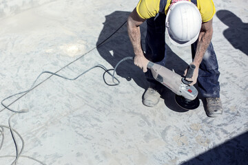 Concrete ceiling surface of the pool grinding by angle grinder