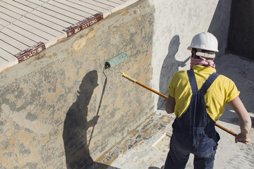 Applying epoxy paint on a surface of a pool