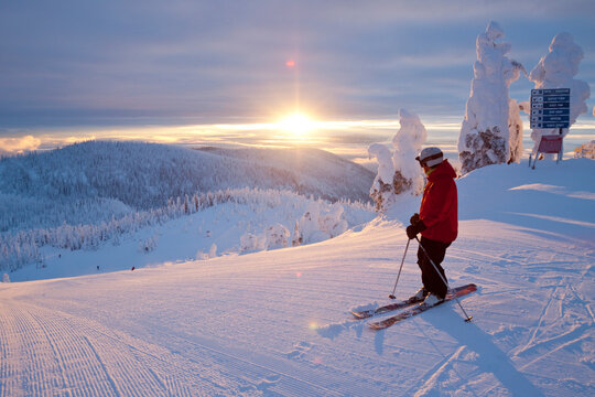 Male Skier Looks Down From The Summit At Whitefish Mountain Resort During Sunrise