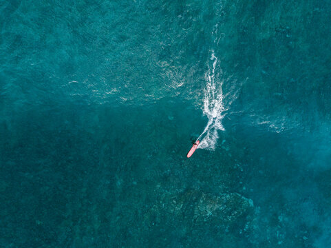 Aerial view of woman surfing on longboard in sea, Tenerife, Canary Islands, Spain
