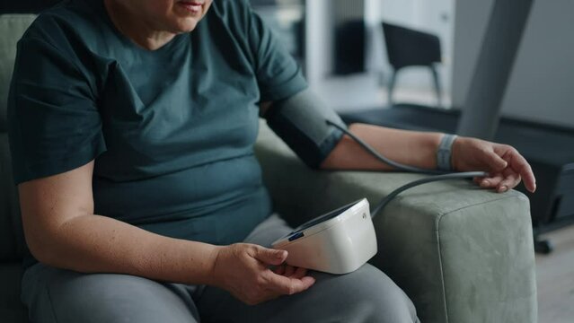 Senior Woman With Hypertension And Overweight Measuring Her Arterial Blood Pressure At Home