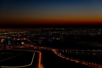 city skyline at sunrise of dubai from the burj khalifa
