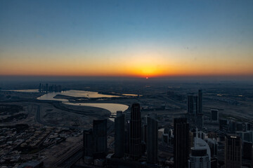 Fototapeta na wymiar city skyline at sunrise of dubai from the burj khalifa