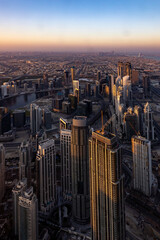 city skyline at sunrise of dubai from the burj khalifa