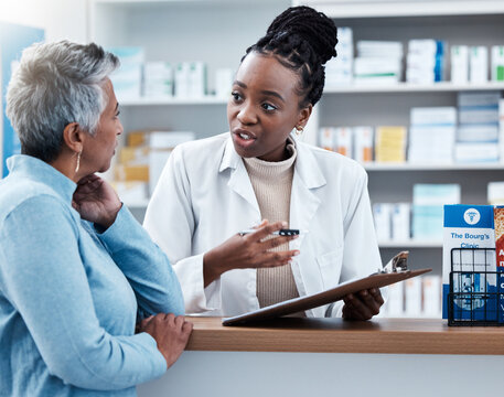 Pharmacy, medical or insurance with a customer and black woman pharmacist in a dispensary. Healthcare, clipboard and trust with a female medicine professional helping a patient in a drugstore