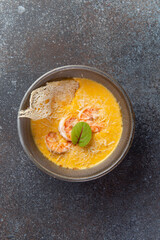 Cream soup with shrimps in a bowl.