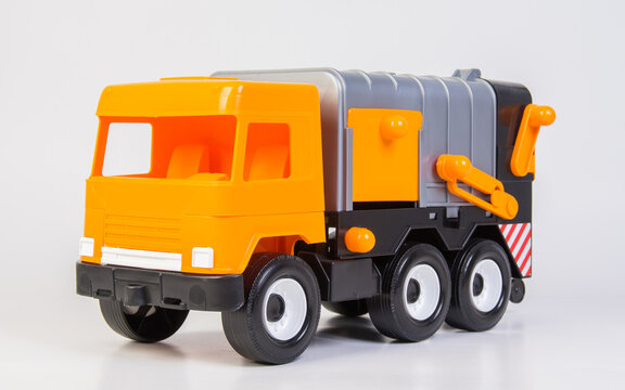 Garbage truck. Multi-colored children's toys plastic trucks on a white background.