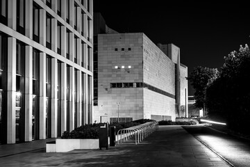 modern urban buildings at night, modern city architecture, black and white photo