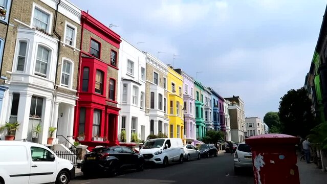 Red letter-box with Lancaster Road colorful houses in background. Notting Hill Neighborhood, London