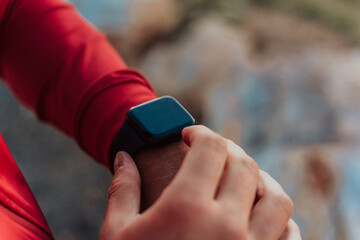 Man Using A Digital Smartwatch During Workout. Closeup View Of Man's Hands Checking An App In Smartwatch. Close-up Of A Clock That Shows Steps, Kilometers And bpm.