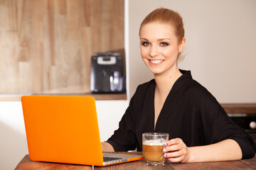Attractive blonde student girl working on computer