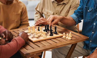 Hands, chess and friends in board games on wooden table for strategic competition, tactical move or decision. Hand of skilled strategy player holding black bishop playing game with friend in tactics