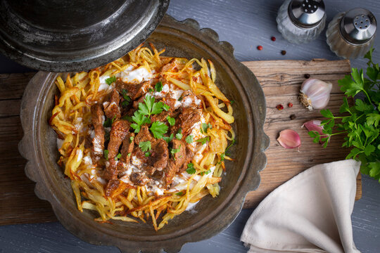 Turkish food; Cokertme Kebab - Beef meat kebab with yoghurt and french fries