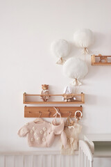 Baby knitted clothes on hanger. Preparation for childbirth.