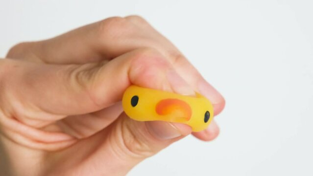 Hands are playing with anti-stress. Close up view on hands play with squash animals. The concept of relieving tension or stress in children and adults. 4K resolution video