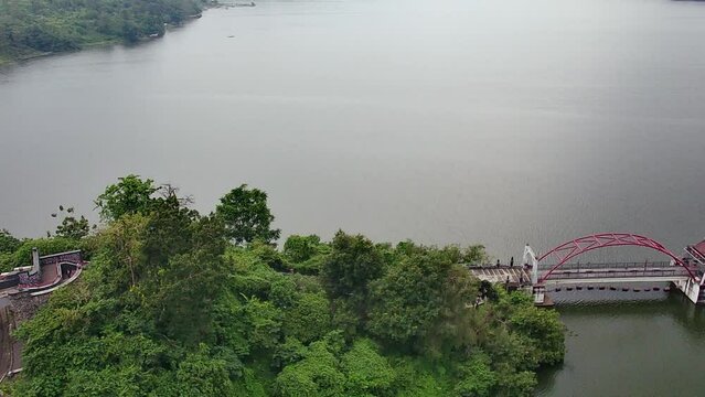 Aerial view of a beautiful reservoir surrounded by green trees in Semarang, Central Java, Indonesia