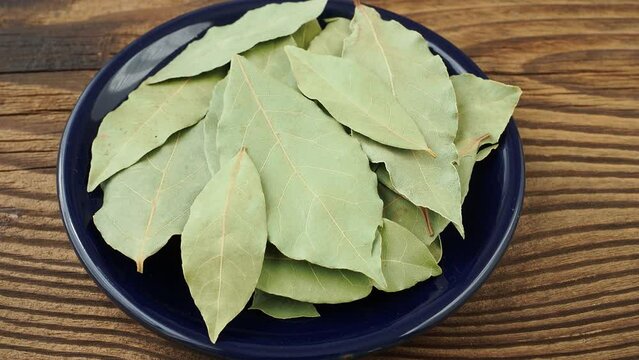 Dried bay leaves in ceramic bowl