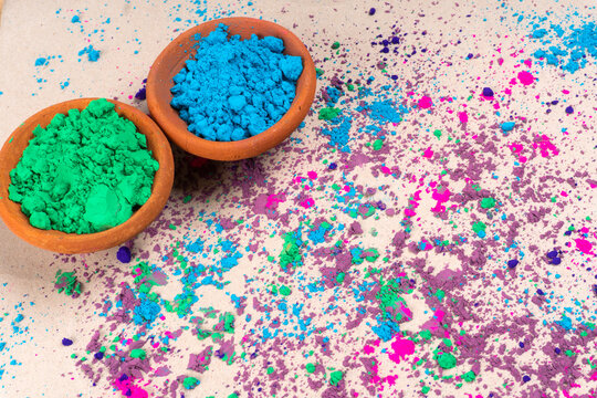 Top view of colorful traditional holi powder in bowls isolated on white background. Space for text. Concept Indian color festival called Holi. © Raksha