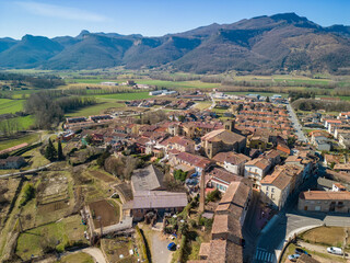 aerial image of la garrotxa in girona la vall d'en bas historic medieval town with beautiful mountains in the background