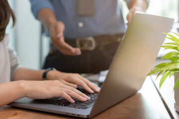 close up young trainee programmer woman hand type on laptop to check about code or bugs on program with expert   try to consult and guide for teamwork concept