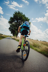 Kleiner Junge geht aus dem Sattel beim Beraufsprint auf einer Fahrradtour durch Niedersachsen in den Sommerferien, Deutschland