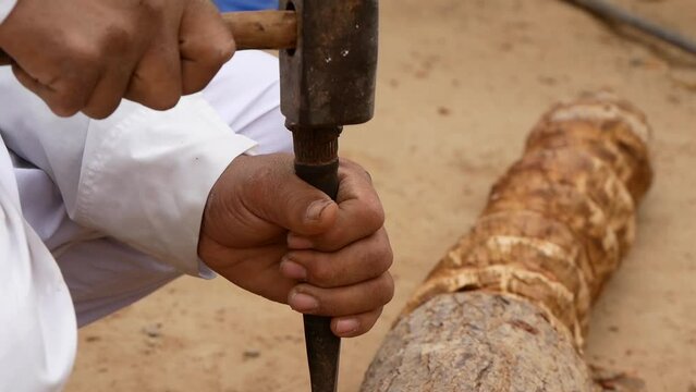 Male Hands Working On Wood With Chisel And Hammer