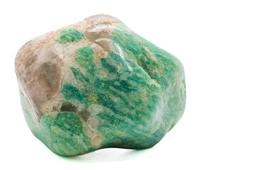 A tumbled chunk of light green and blue amazonite crystal with a clear quartz matrix focused and isolated on a white surface background