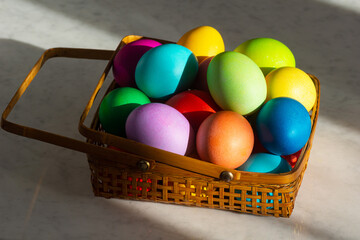 Basket Full of Colorful Dyed Easter Eggs in Rainbow Colors for the Holiday