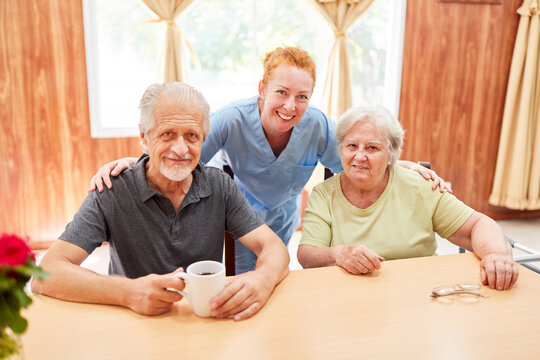 Happy Senior Couple And Geriatric Nurse