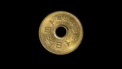 Obverse of Japan coin 5 yen 2004 with inscription meaning JAPAN 2004, isolated in black background. 4k video