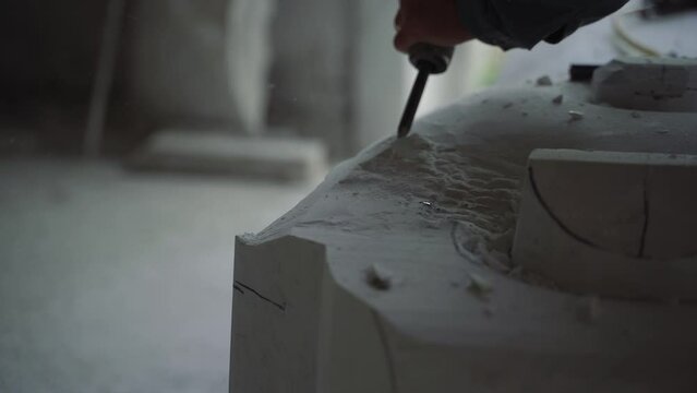Watch a skilled sculptor at work in their studio as they hand-carve a block of stone into a beautiful work of art. Follow the intricate process and see the final result come to life in stunning detail