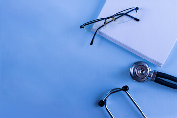 Doctor's set: a notebook for recording patient complaints, a pen, a fanendoscope, glasses. Medical...