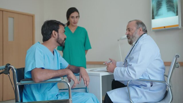 Indian male patient getting treatment for depression and talking with senior male doctor at the hospital