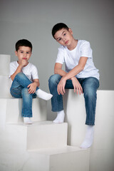 two brothers sitting in white t-shrt