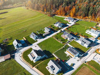Sunny day in the suburbs, aerial view of new housing development bellow