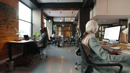Professionals from different backgrounds sharing a workspace in a coworking office