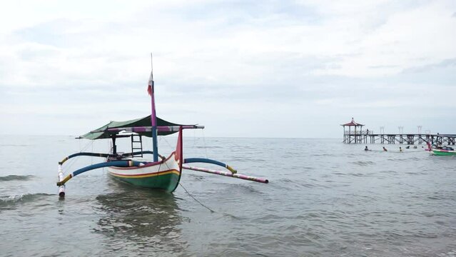 Situbondo, Indonesia - March 12 2023.

Indonesian fishing boats are leaning on the beach